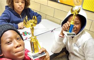 2 SWA young men pose with the tropies
